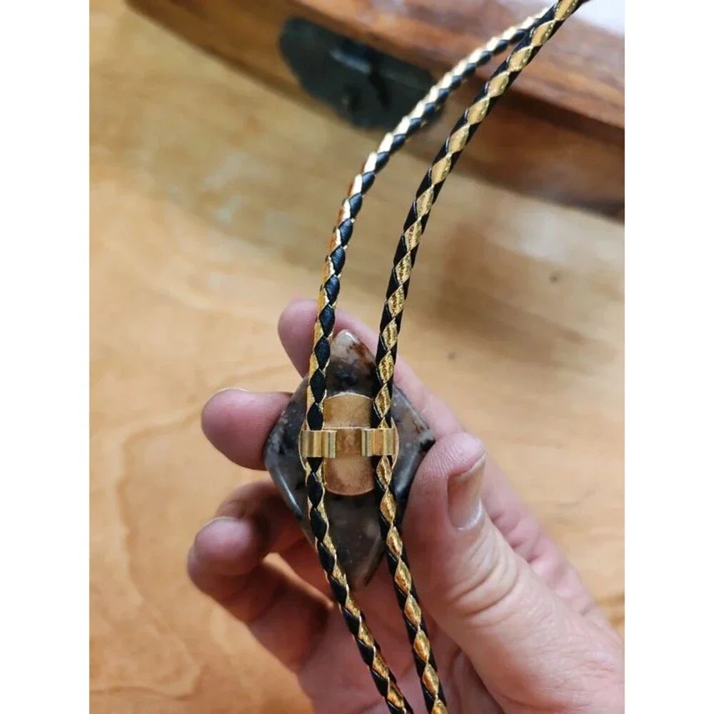 Fancy  agate bolo tie on gold and black cord